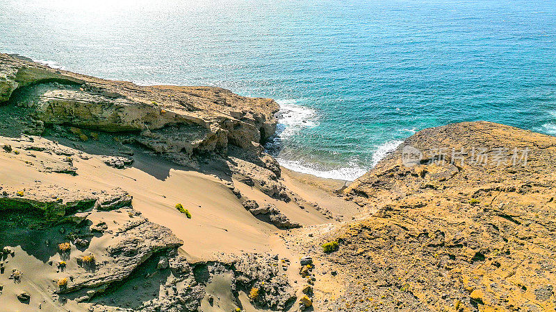 Aerial view of the hidden cove beach "La Rajita" at the natural reserve of "Monta?a Pelada" in Tenerife (Canary Islands). Drone shot